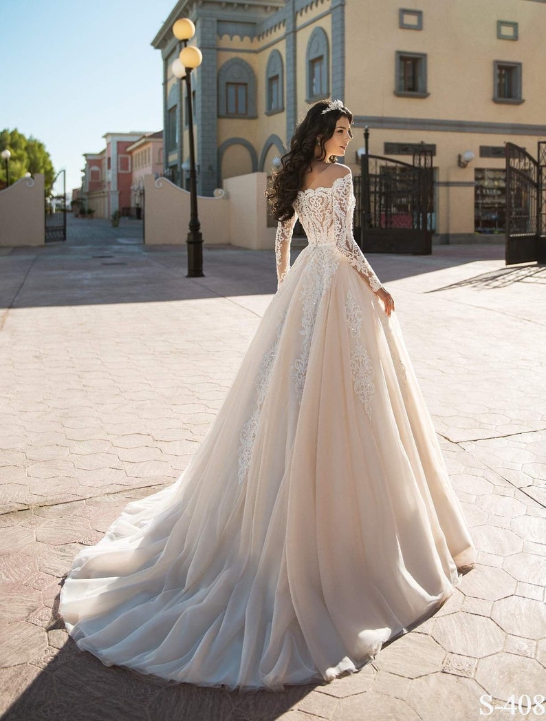 Lace wedding dress with corset an off-shoulder and long lace image 0