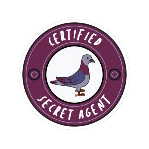 May include: A purple and white round sticker with the text "CERTIFIED SECRET AGENT" and a cartoon image of a gray pigeon.