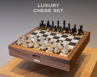 May include: A luxury chess set with a wooden board featuring a dark wood frame and a black and white checkered surface. The set includes white and black chess pieces with gold-toned bases. The text LUXURY CHESS SET is visible above the board.