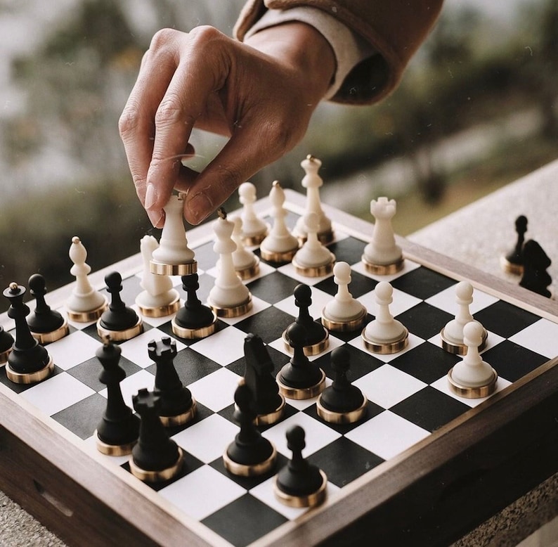 📐 Chessboard Box Specifications
❖ Dimensions: 11 inches x 11 inches x 2 inches
- Size of each square on the game area: 1.14 inches x 1.14 inches 
- Weight: 3.5 kg

❖ Chess piece sizes:
  - Pawn: 1.49 inches high, 
  - King: 2.67 inches high,