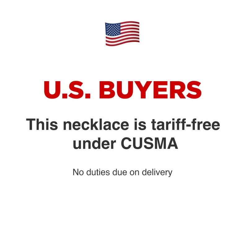 May include: A graphic featuring the United States flag icon above the red text U.S. BUYERS. Below this, black text reads: This necklace is tariff-free under CUSMA. The final line of text states: No duties due on delivery. The background is plain white.