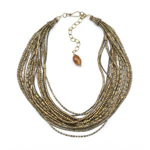 Fifteen strands of vintage African brass tube beads and tiny round Indian brass beads create this luminous, textured multistrand necklace.