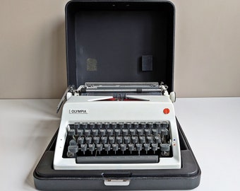 Vintage typewriter, Olympia De Luxe, mechanical portable typewriter in a suitcase