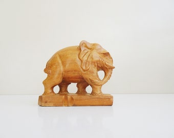 hand carved elephant made of light wood, mid century wooden decoration