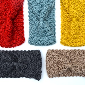 May include: Five crocheted headbands in various colors: red, blue, yellow, dark gray, and tan. Each headband features a twisted knot design in the center. The headbands are made of a textured yarn.