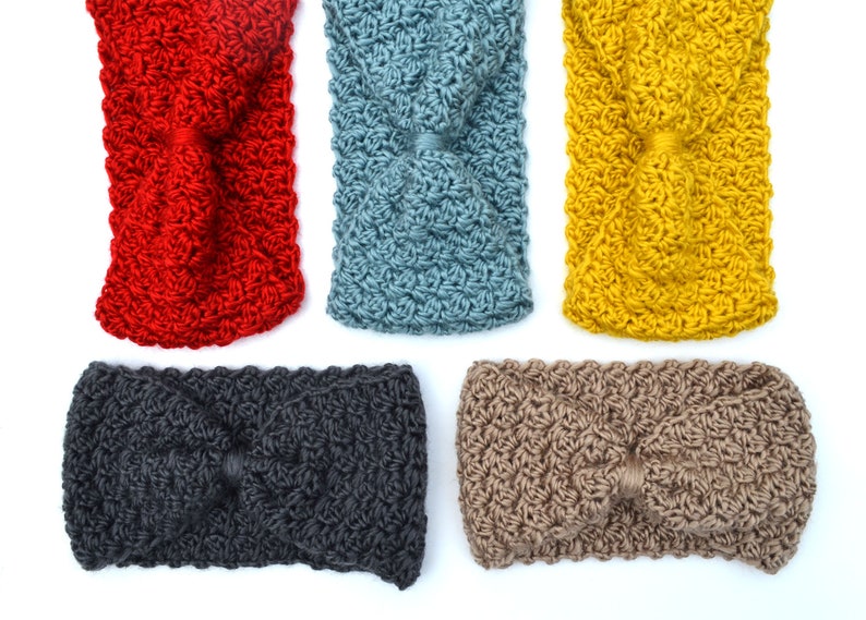 May include: Five crocheted headbands in various colors: red, blue, yellow, dark gray, and tan. Each headband features a twisted knot design in the center. The headbands are made of a textured yarn.
