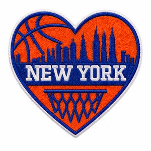 May include: A heart-shaped embroidered patch featuring an orange background with a blue basketball graphic in the upper left corner, a blue New York City skyline silhouette, the white text NEW YORK, and a blue basketball hoop net at the bottom.