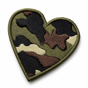 May include: A heart-shaped embroidered patch featuring a camouflage pattern in shades of olive green, black, brown, and tan. The patch has a thick, stitched olive green border that outlines the heart shape, providing a clean, finished edge.