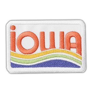 May include: A white embroidered patch with the word "iouia" in orange letters with a wavy rainbow design underneath.