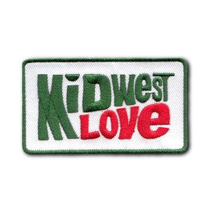 May include: Embroidered patch with the words "Midwest Love" in green and red lettering. The patch has a white background and a green border. The design is rectangular.