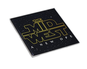May include: A black square button with a gold outline of the text "The Mid West A New Hope" on a black background with white stars.