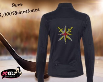 May include: Black long-sleeve shirt with a red and yellow star design featuring swords. The text "Over 2,000 Rhinestones" is printed on the shirt.