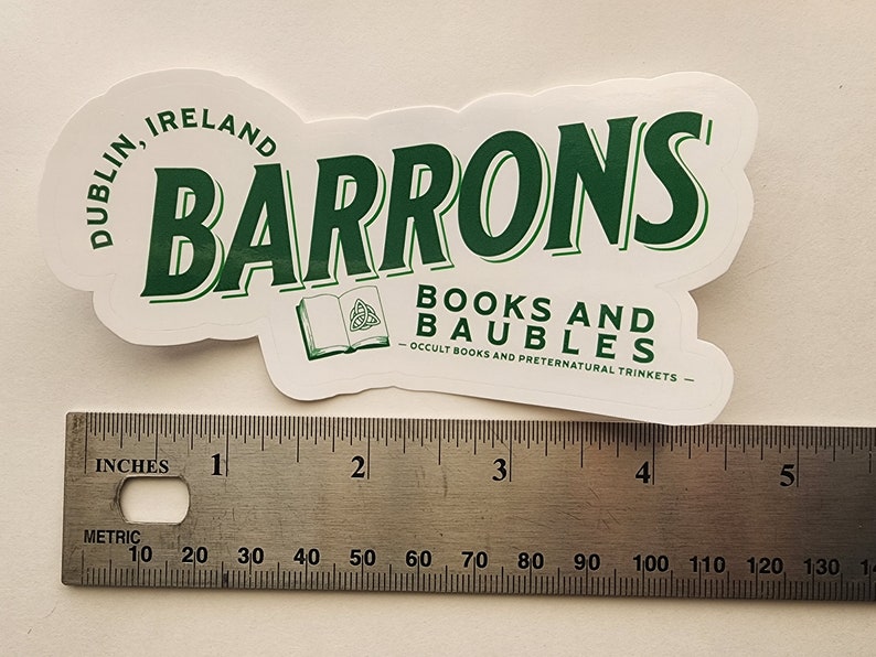 May include: A white sticker with green text that reads "Barrons Books and Baubles - Occult Books and Preternatural Trinkets - Dublin, Ireland". The sticker is about 4 inches wide.