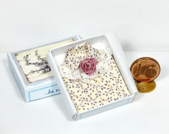 Miniature folded woman's blouse, in combined box, 1/12 scale.