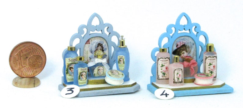 May include: Two miniature blue and white vanity sets with a mirror, bottles, and jars. The sets are on a white background.