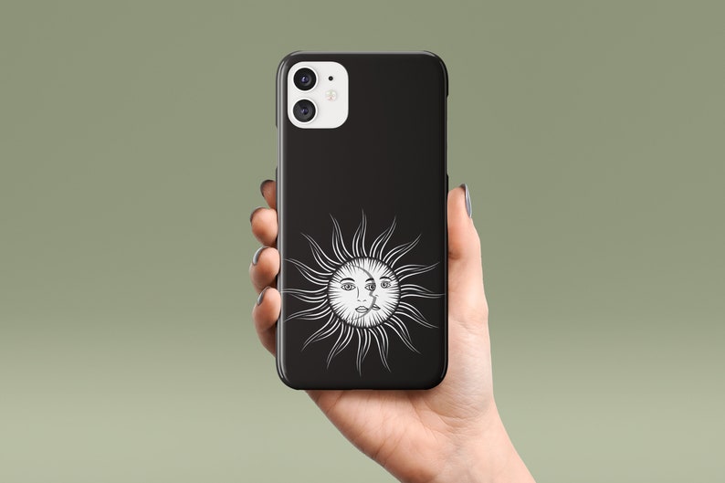 May include: Black phone case with a white sun and moon design. The sun has a face and the moon has a crescent shape.