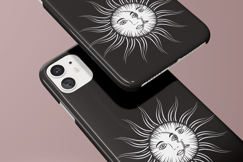 May include: Two black phone cases with a white sun and moon design. The sun and moon have faces and are surrounded by rays.