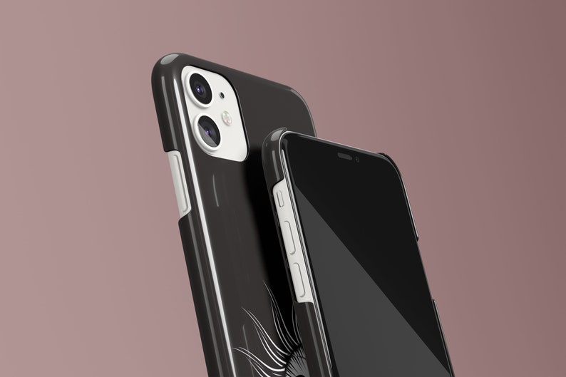 May include: Two black phone cases with white accents. The case on the left has a camera lens cutout and a white border. The case on the right has a black screen and a white border.