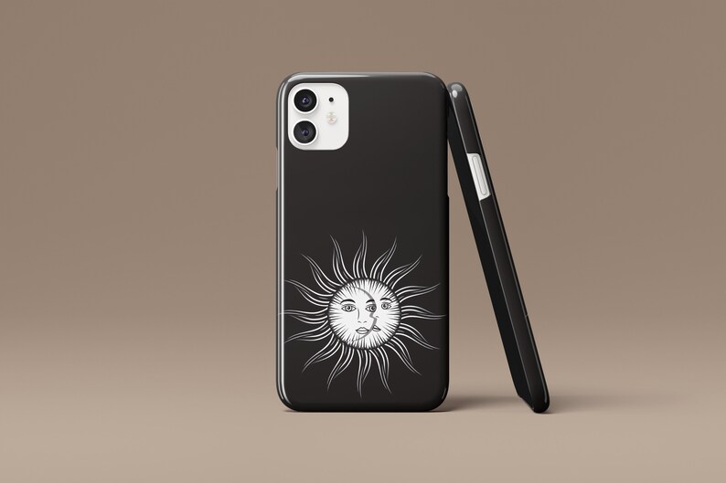 May include: Black phone case with a white sun and moon design. The sun has a face and the moon is a crescent shape.