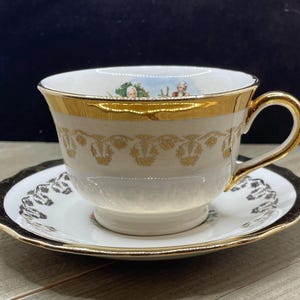 Victorian Couple Warrented 22-K-Gold Teacup with Saucer