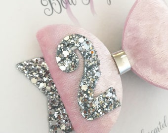 May include: Pink velvet hair bow with a silver glitter number 2. The bow is attached to a silver alligator clip. The bow is labelled "Bow Peep Bigcartel".