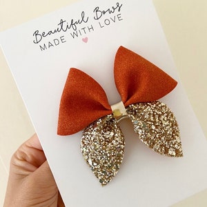 Herfsthaarstrik, glitterhaarstrik, meisjeshaarstrik, strikken voor meisjes, haarelastiekjes in het Verenigd Koninkrijk, haarstrik, babystrikken, oranje haarelastiekjes, strikken