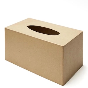 May include: A rectangular tissue box cover made of light brown, textured cardboard material. The box features a smooth, matte finish with a centered, elongated oval-shaped opening on the top surface for dispensing tissues from the container.