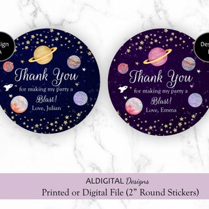 May include: Two round thank you stickers with a space theme. The stickers have a dark blue and purple background with gold stars and planets. The text on the stickers reads "Thank You for making my party a Blast!" with the name "Julian" or "Emma" at the bottom.