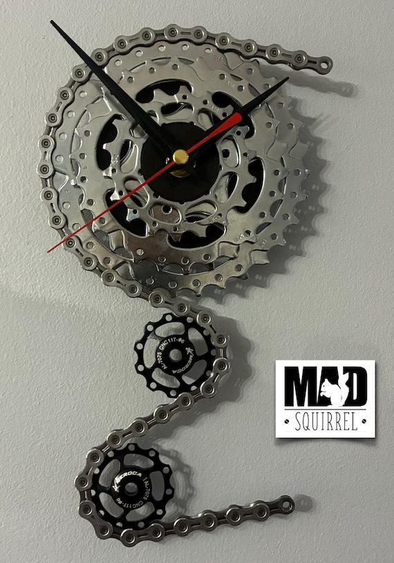 Triple Sprocket and Jockey Wheel Clock, depicting a bike derailleur and cassette, in Chrome and Small Black Face and Black and Red hands