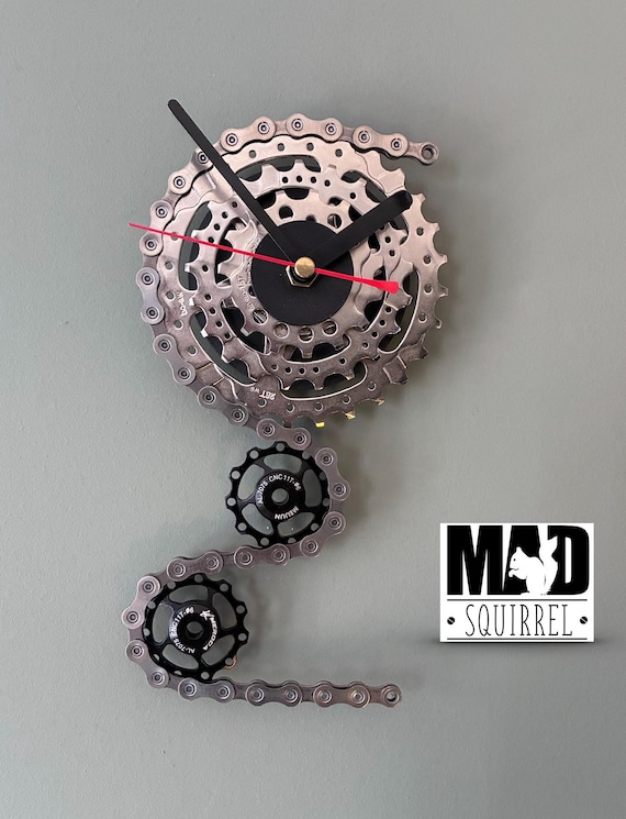 Triple Sprocket and Jockey Wheel Clock, depicting a bike derailleur and cassette, in Chrome and Small Black Face and Black and Red hands