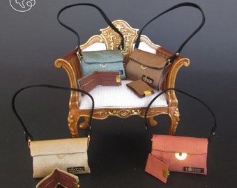 May include: Four miniature leather handbags with matching wallets, each in a different color: teal, brown, beige, and orange. The handbags are displayed on a miniature wooden chair with a white cushion.