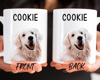 May include: White ceramic mug with a golden retriever dog illustration and the word "COOKIE" printed on the front and back. The mug is held by a hand.