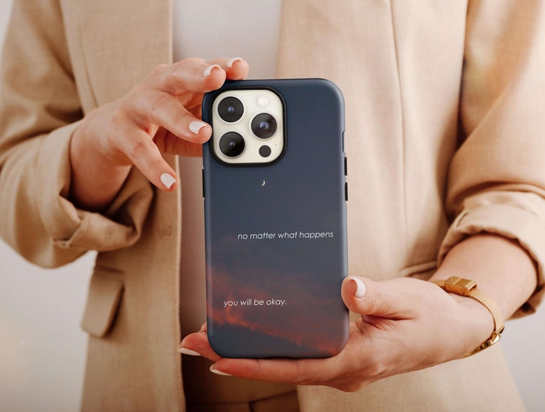 May include: A blue phone case with a sunset background and the text "no matter what happens you will be okay."