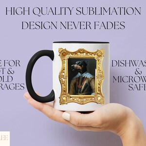 a person holding a coffee mug with a painting on it