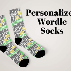 May include: Two pairs of personalized Wordle socks. The socks are gray with a grid pattern, featuring the words "PUT YOUR TEXT HERE" in green, yellow, and white. The heels and toes are black.