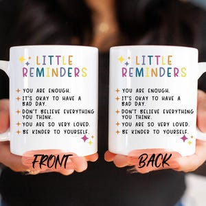 two coffee mugs with words written on them