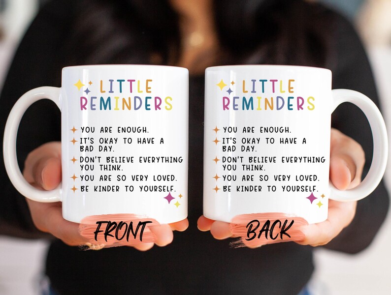 two coffee mugs with words written on them