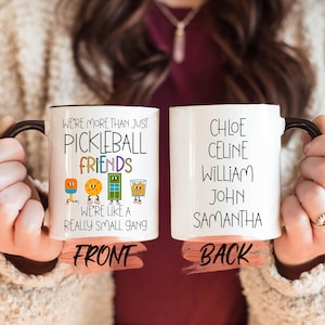 a woman holding two coffee mugs with words on them