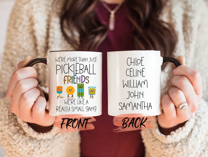 a woman holding two coffee mugs with words on them