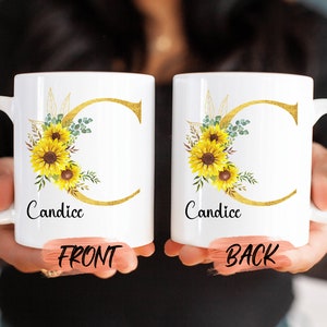 Puede incluir: Taza de cerámica blanca con una letra C dorada y un diseño de girasol. La taza dice "Candice" en la parte delantera y trasera.