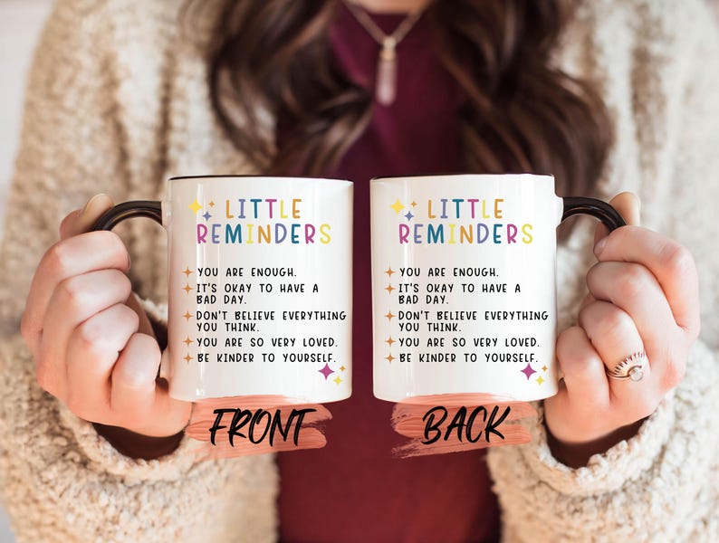 a woman holding two coffee mugs that say, little reminderers