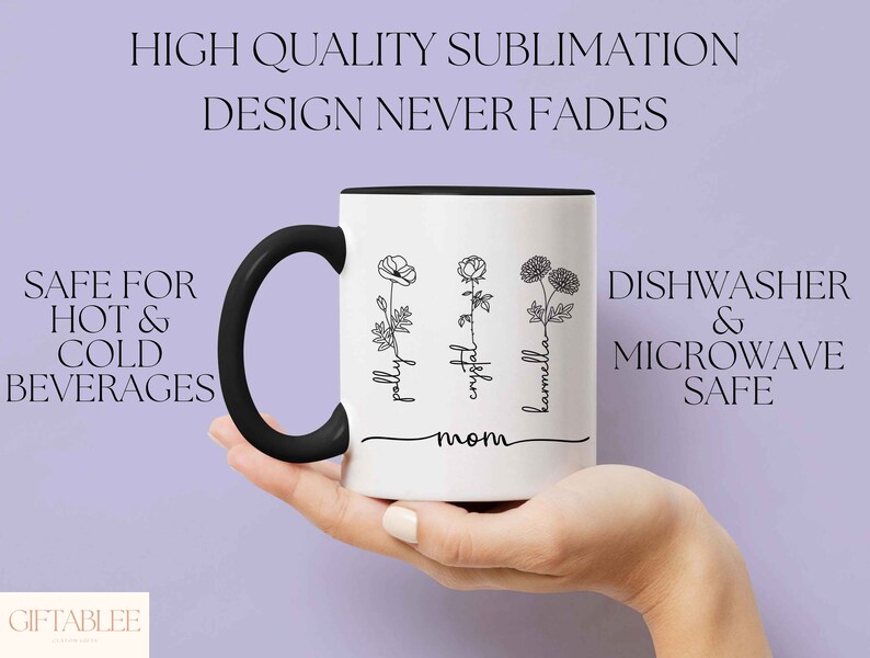 May include: White ceramic mug with a black handle and rim, featuring floral line art and the names "pally", "crystal", and "karmella". Text on the mug reads "mom", "Safe for Hot & Cold Beverages", and "Dishwasher & Microwave Safe".