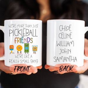 two white coffee mugs with words on them