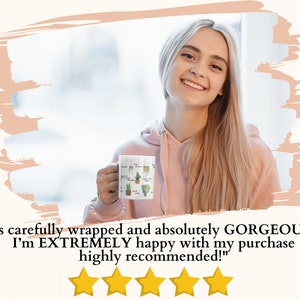 May include: A woman holding a white ceramic mug with a green and brown illustration of potted plants. The mug has the text "It's carefully wrapped and absolutely GORGEOUS!!!! I'm EXTREMELY happy with my purchase highly recommended!" printed on it. Five yellow stars are below the text.