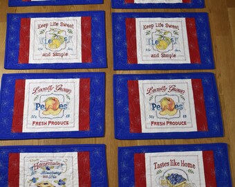 Handmade set of 8 placemats with fruit motiff, in blue and red, with a red backing, custom machine quilted