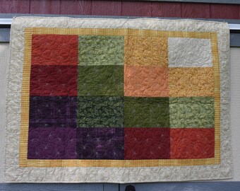 Fall quilt custom machine quilted in an apple motiff.  Fall colors.  Pattern available to make a memory quilt.