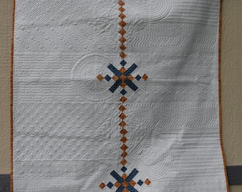 Handmade quilt in white, gold and turquoise with detailed custom quilting