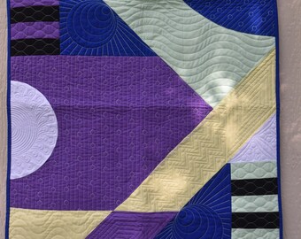 Geometric custom quilted wall hanging or table topper in blue, purple, yellow, white and green cotton fabrics
