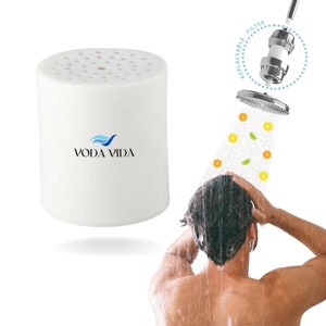 May include: White cylindrical shower filter with the text "VODA VIDA" and a blue wave logo. The filter is replaceable and has a shower head with a spray of water and fruit slices.