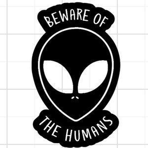 May include: Black and white sticker featuring an alien face with the text "Beware of the Humans".